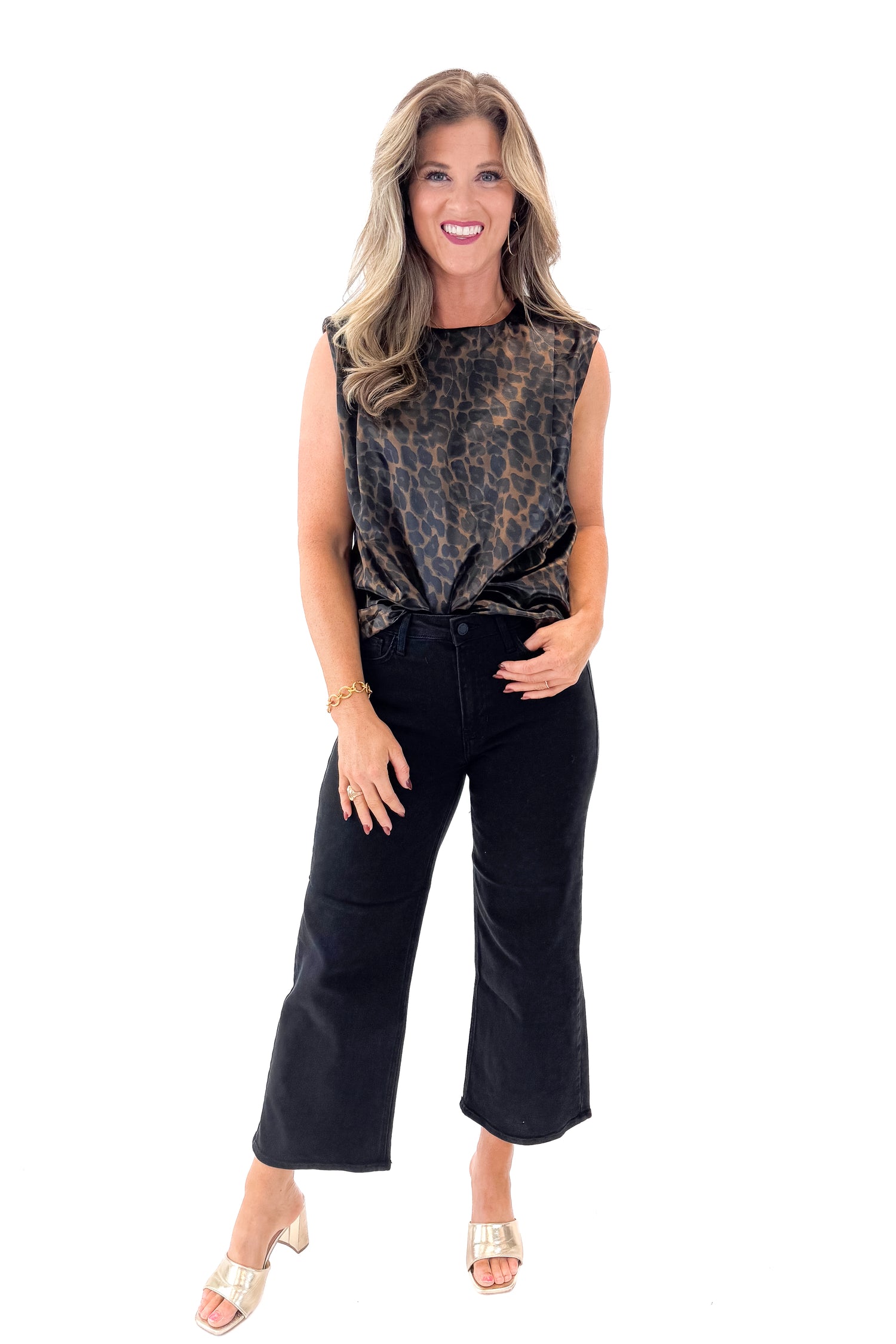 Front view of woman wearing Leopard Satin Sleeveless Top with jeans against white studio background.