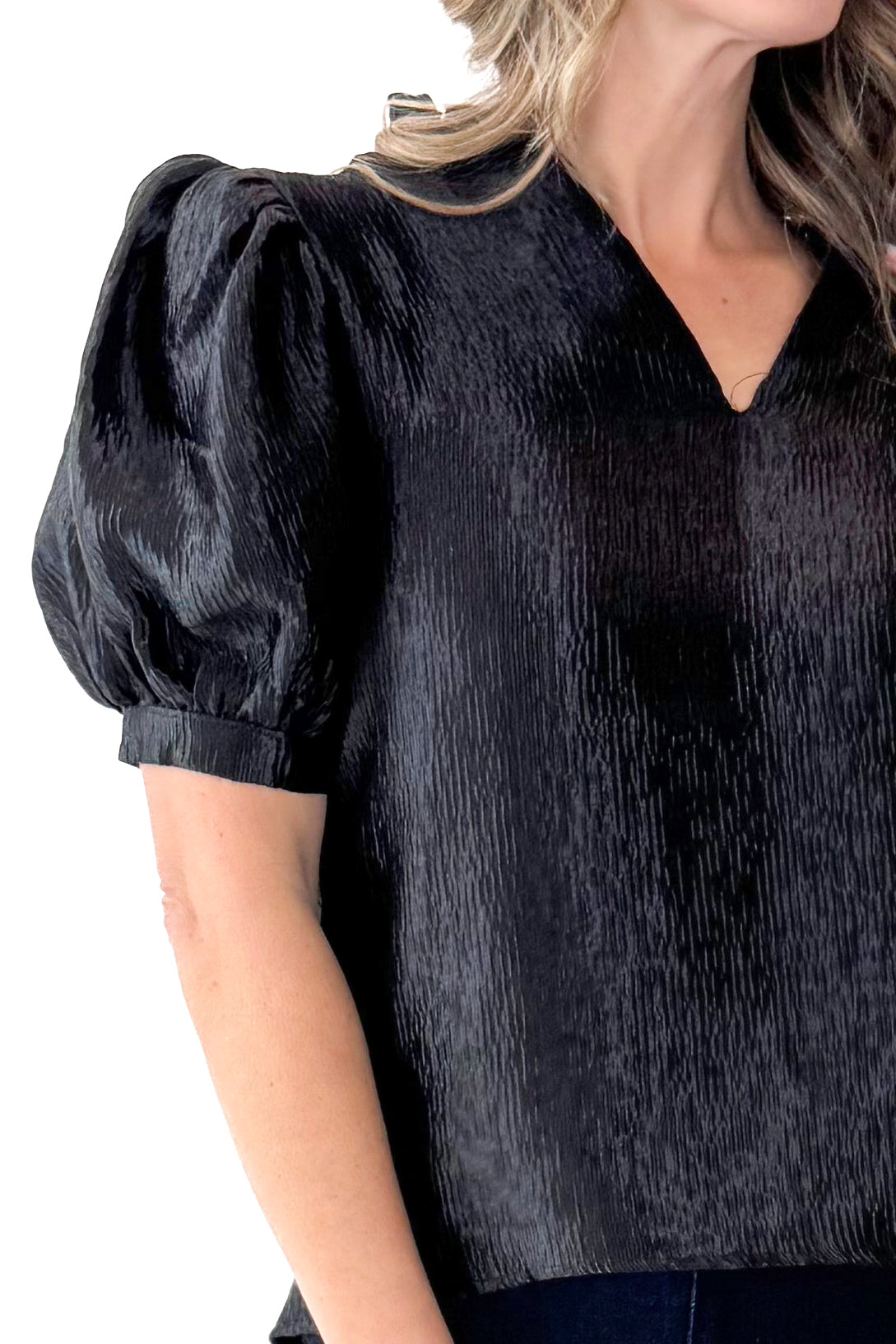Front detail view of woman wearing Black Sheen Textured Puff Sleeve Top with jeans against white studio background.
