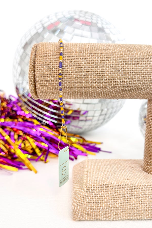 Closeup shot of enewton purple and yellow beaded bracelet