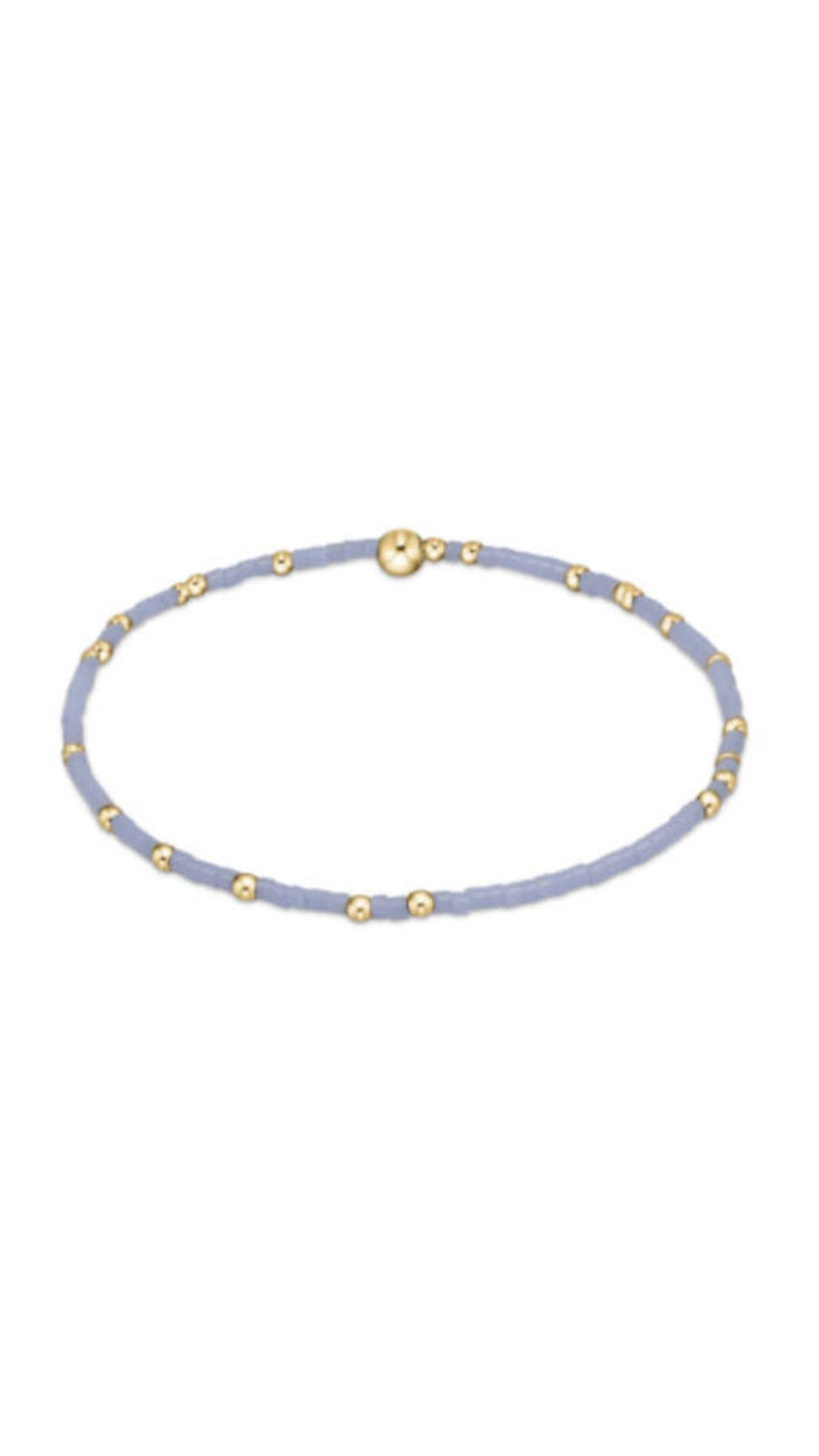 A light blue beaded bracelet with small gold spacer beads and a gold magnetic clasp, shown on a plain white background.
