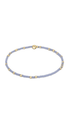 A light blue beaded bracelet with small gold spacer beads and a gold magnetic clasp, shown on a plain white background.
