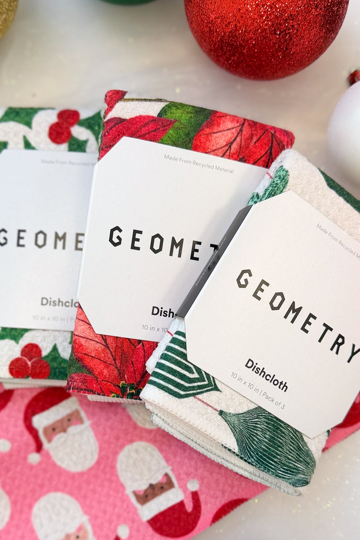 Geometry Festive Holly Dishcloth Set against holiday background.