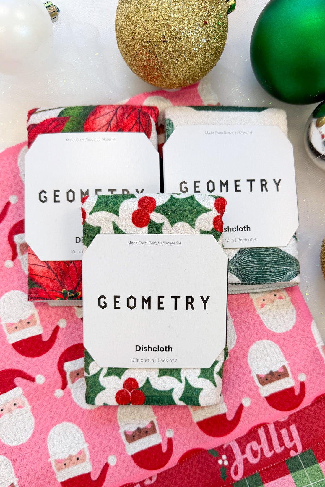 Geometry Festive Holly Dishcloth Set against holiday background.