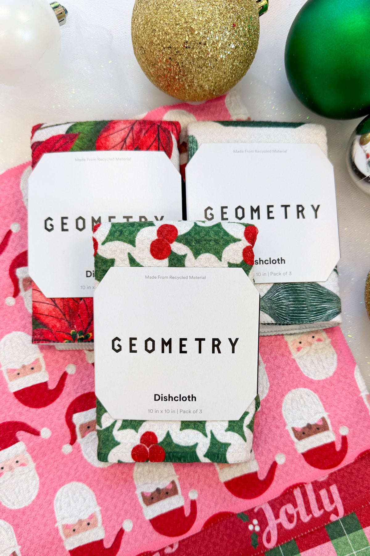 Geometry Festive Holly Dishcloth Set against holiday background.