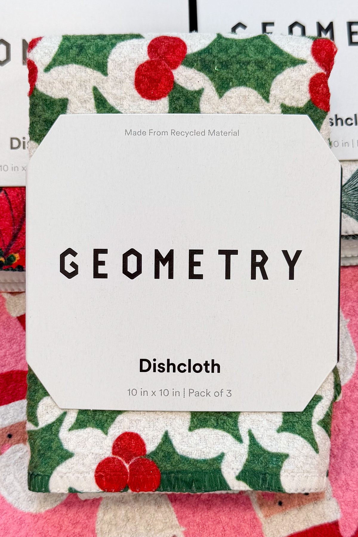 Geometry Festive Holly Dishcloth Set against holiday background.