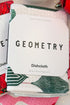 Geometry Festive Holly Dishcloth Set against holiday background.