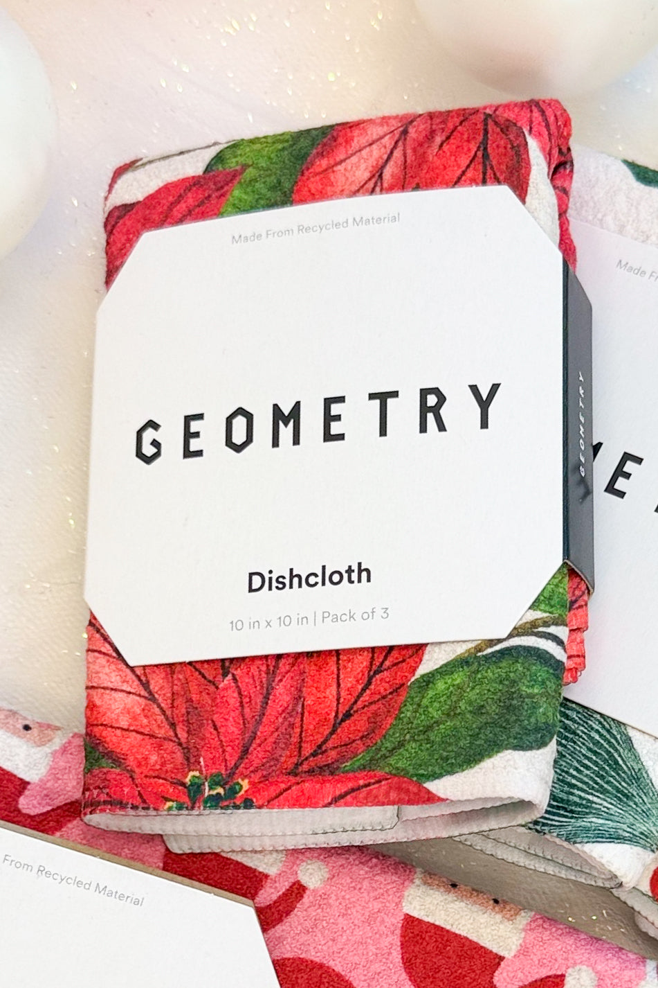 Geometry Festive Holly Dishcloth Set against holiday background.