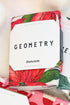 Geometry Festive Holly Dishcloth Set against holiday background.