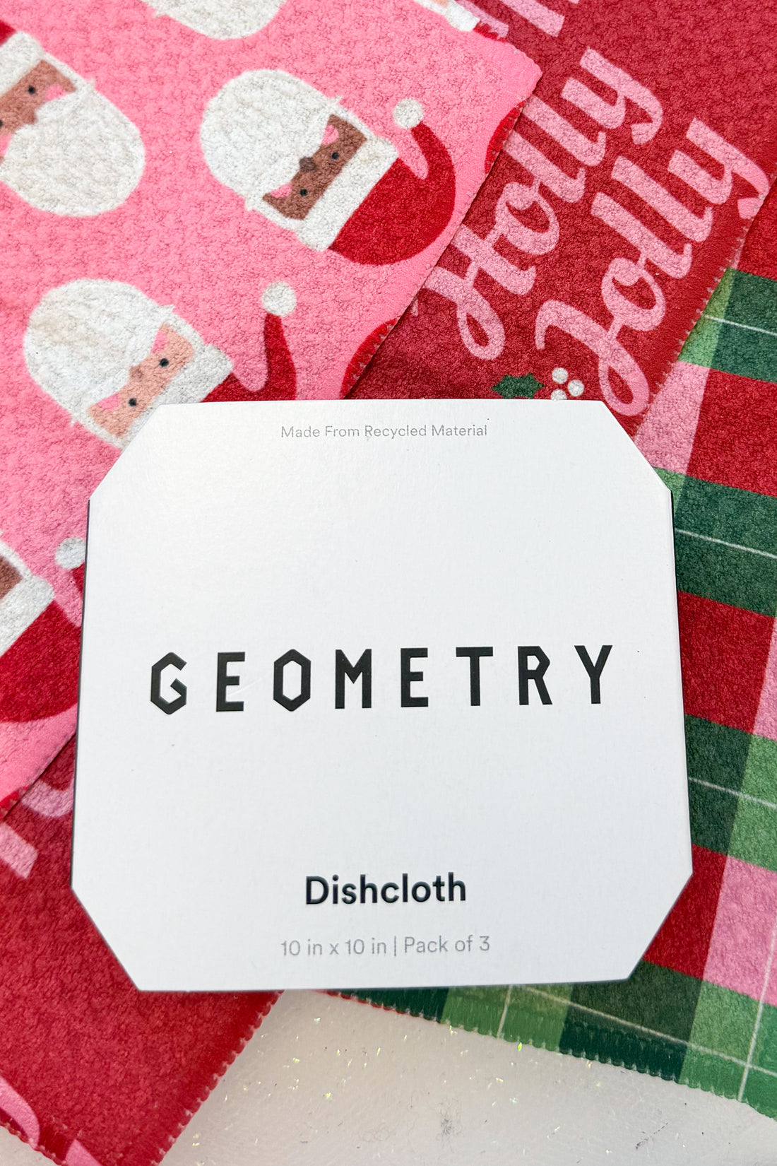 Geometry Festive Holly Dishcloth Set against holiday background.