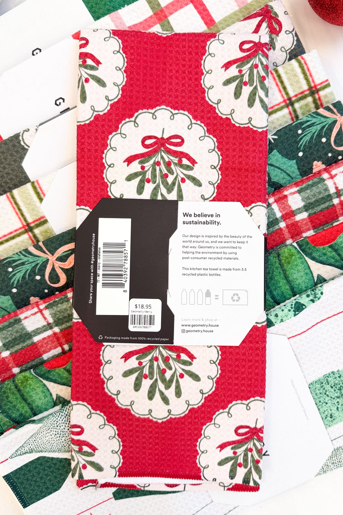 Geometry Merry Mistletoe Microfiber Tea Towel against holiday background.
