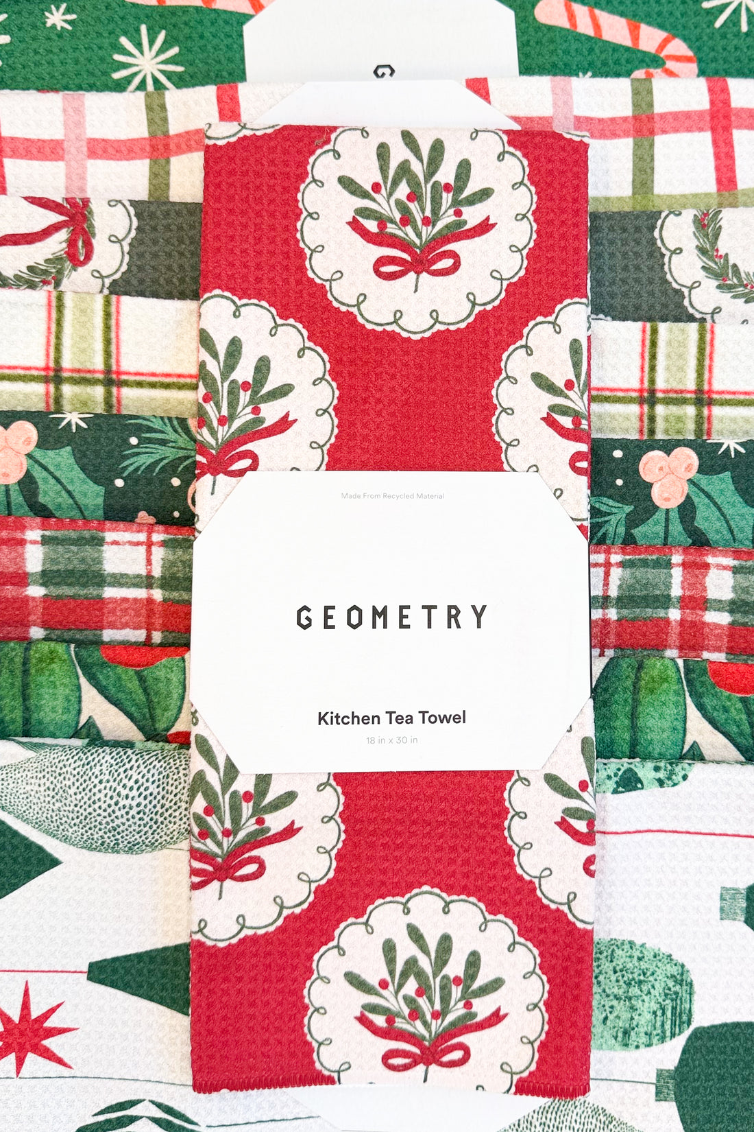 Geometry Merry Mistletoe Microfiber Tea Towel against holiday background.