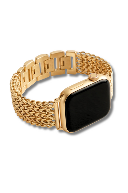 A gold-toned metal watch band with a woven mesh pattern and rectangular link design, shown fitted on a smartwatch with a black screen against a white background.