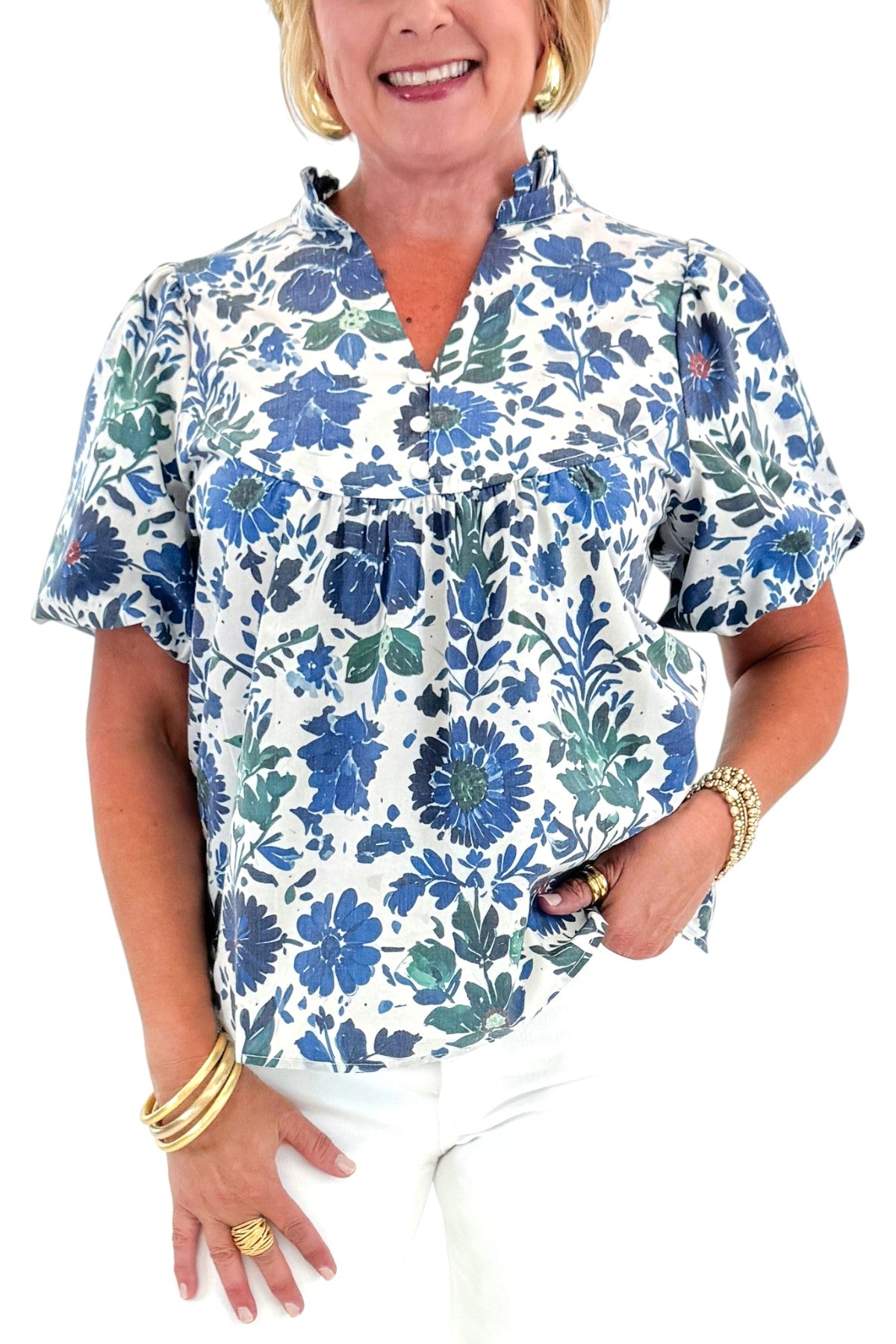 Front detail view of woman wearing Swagger Boutique’s Green &amp; Blue Floral V-Neck Top with sandals against white studio background.