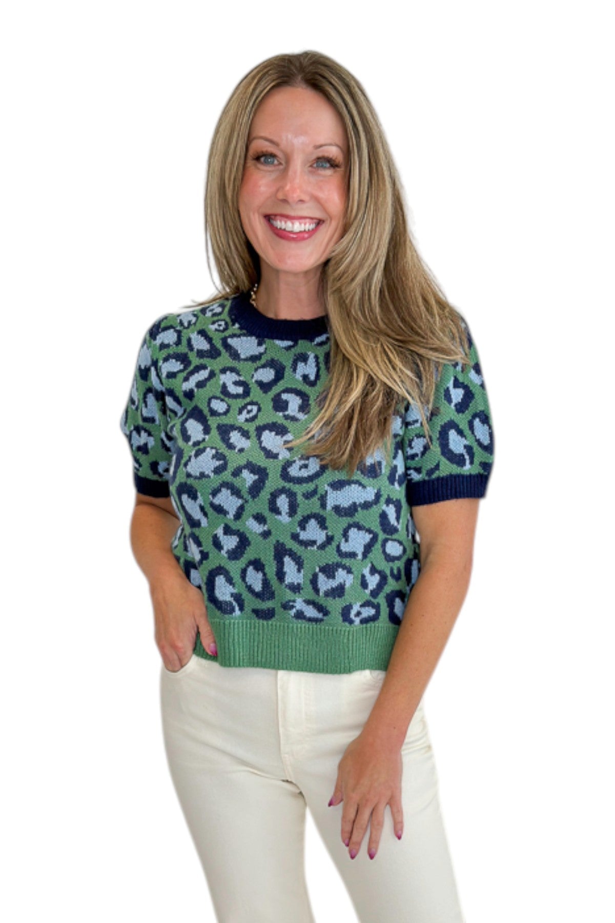 Front view of woman wearing Swagger Boutique’s Green &amp; Blue Leopard Short Sleeve Sweater with jeans against white studio background.