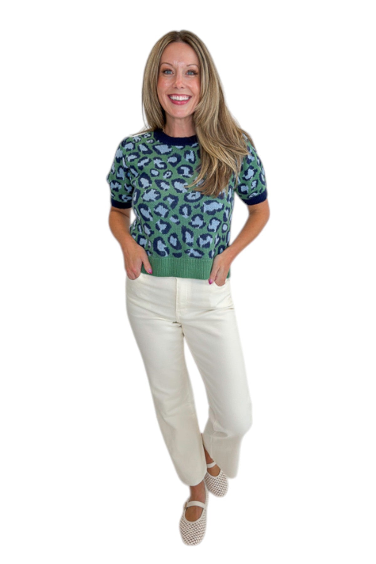 Front view of woman wearing Swagger Boutique’s Green &amp; Blue Leopard Short Sleeve Sweater with jeans against white studio background.