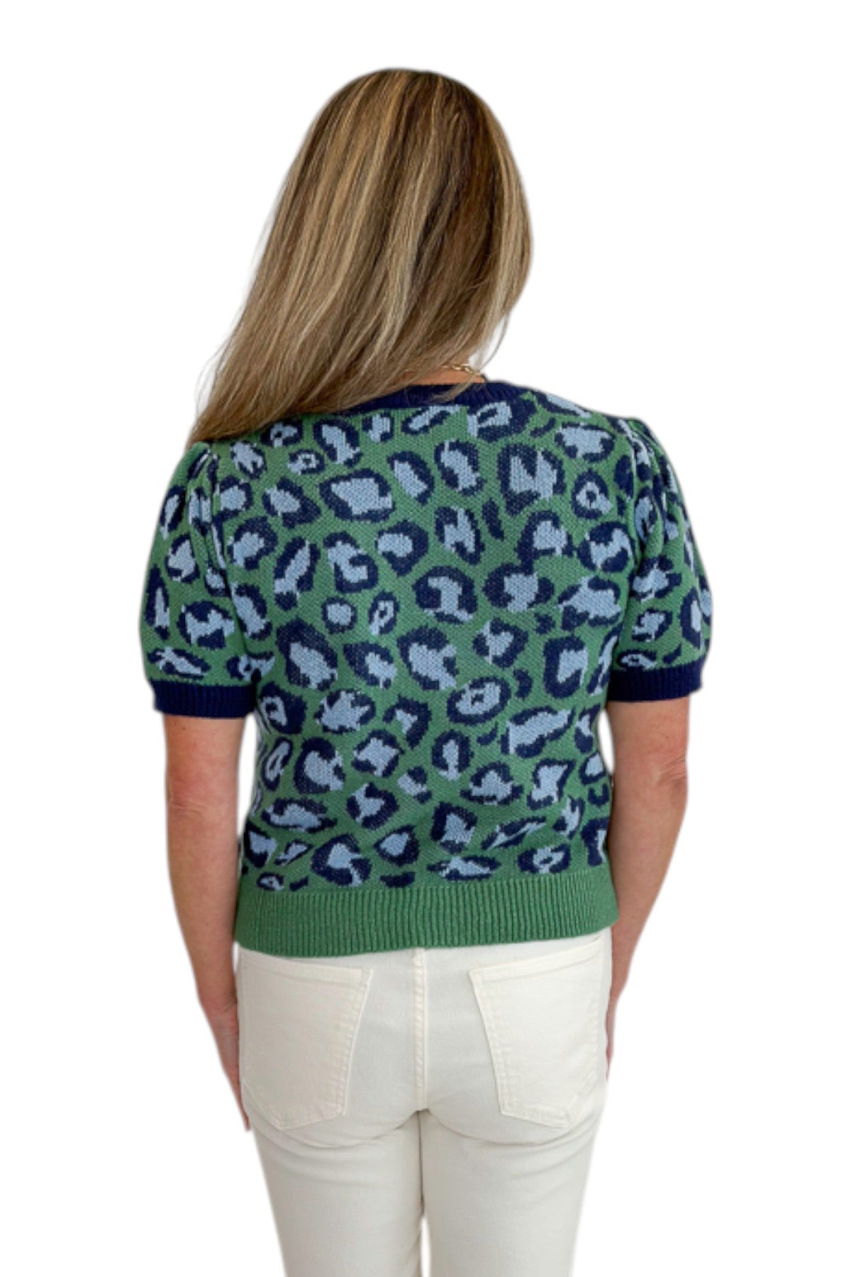 Back view of woman wearing Swagger Boutique’s Green &amp; Blue Leopard Short Sleeve Sweater with jeans against white studio background.