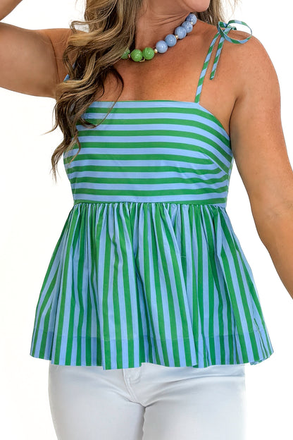 Front detail view of woman wearing Swagger Boutique’s Green &amp; Blue Striped Peplum Tank by Entro with jeans against white studio background.