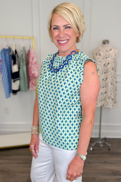 Woman wearing Green &amp; Blue Abstract Printed Tank top in a clothing store setting