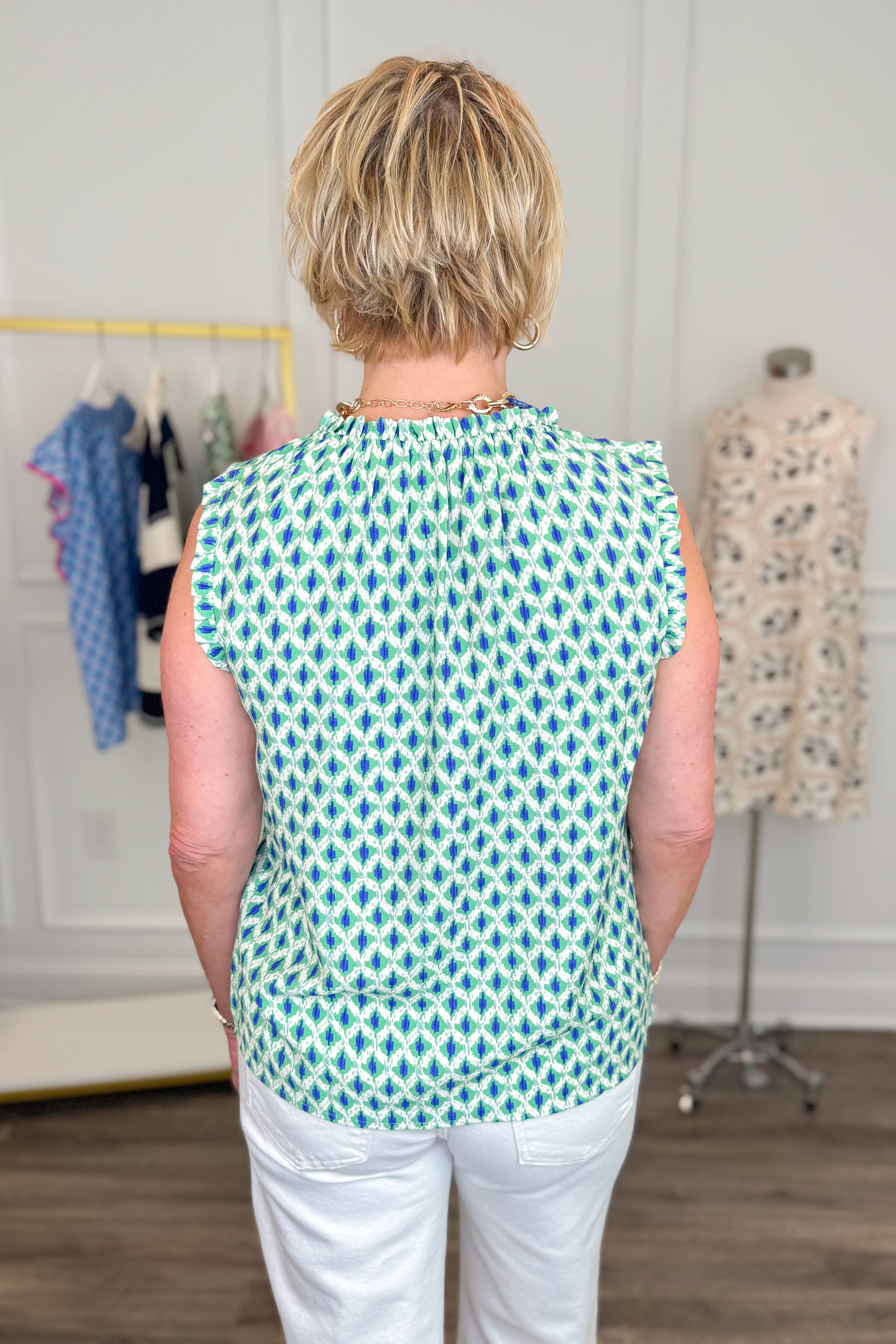 Person wearing a Green &amp; Blue Abstract Printed Tank top in a clothing store setting