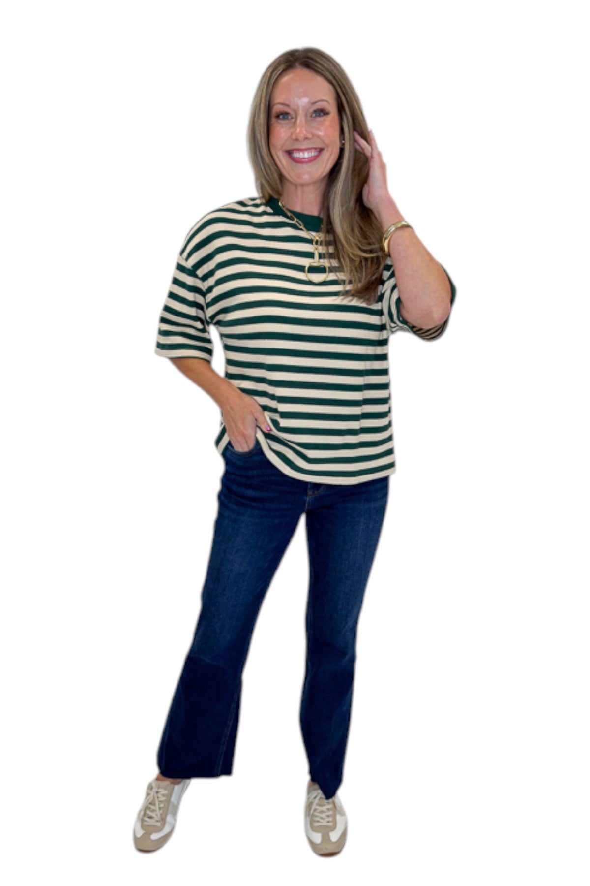 Front view of woman wearing Swagger Boutique’s Green &amp; Cream Striped Textured Tee by Entro with jeans against white studio background.