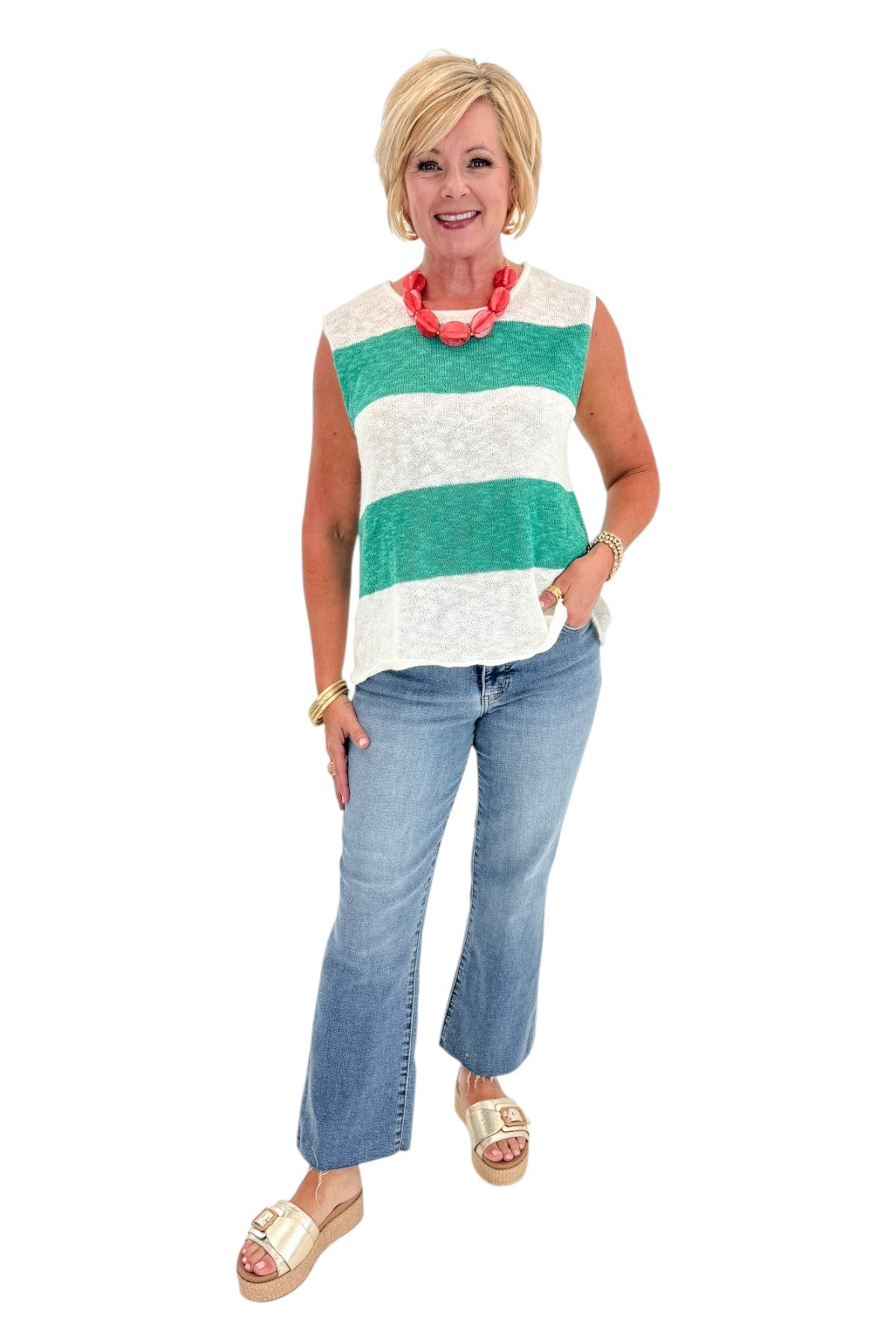 Front view of woman wearing Swagger Boutique’s Green &amp; White Striped Sleeveless Sweater with jeans against white studio background.