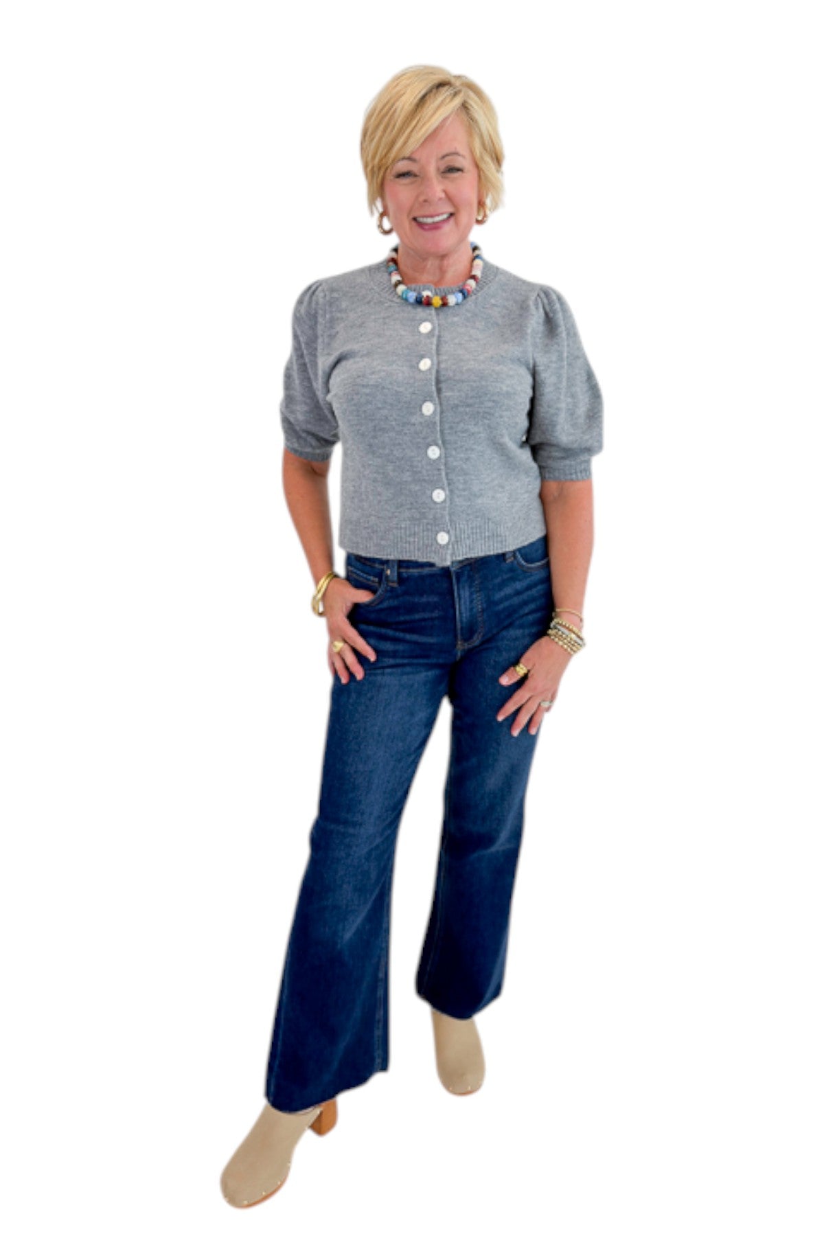 Front view of woman wearing Swagger Boutique’s Grey Button Up Short Sleeve Cardigan with jeans against white studio background.