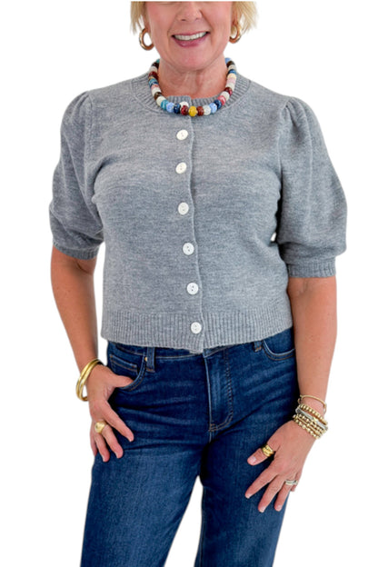 Front detail view of woman wearing Swagger Boutique’s Grey Button Up Short Sleeve Cardigan with jeans against white studio background.