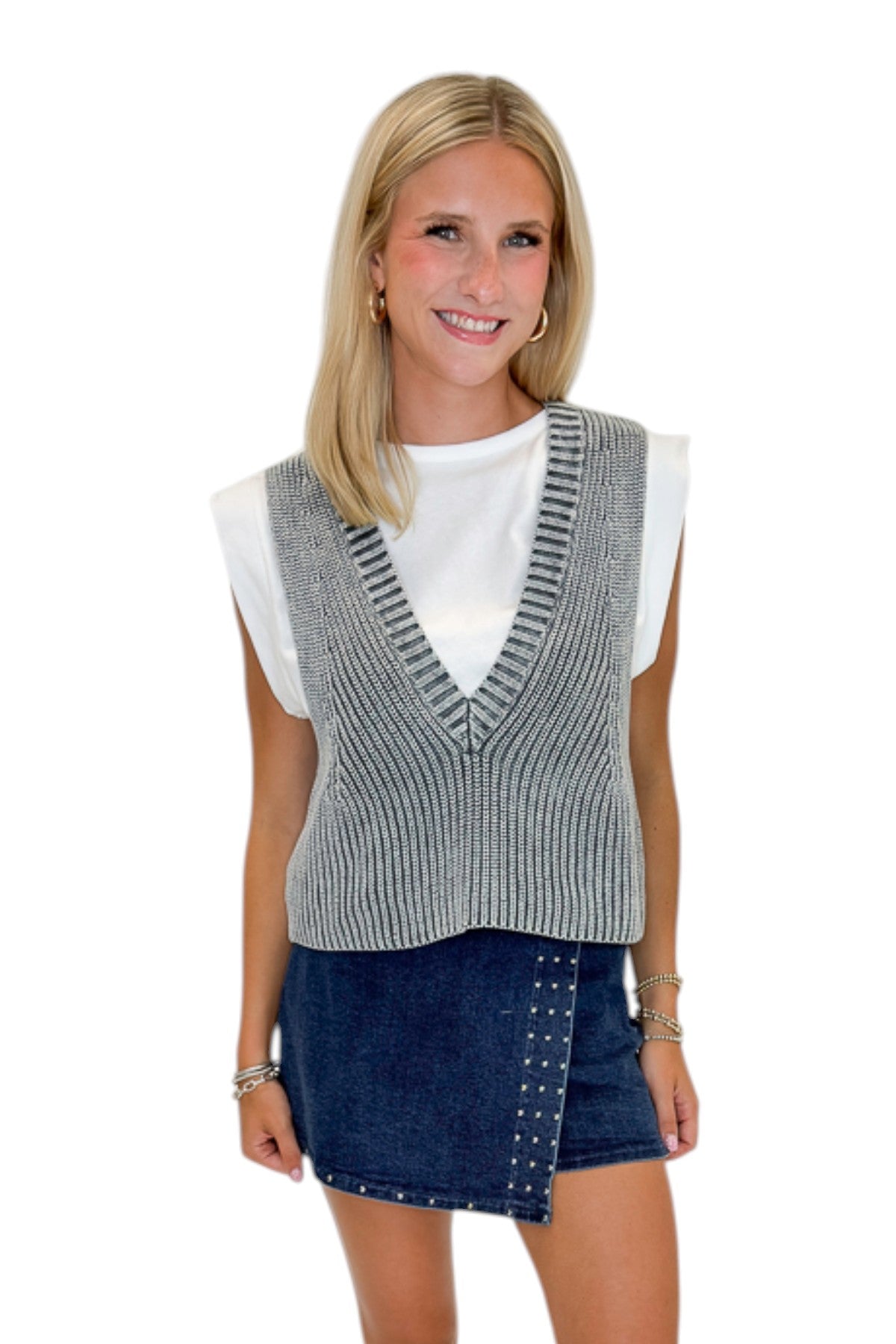 Front view of woman wearing Swagger Boutique’s Grey Layered Sweater Top with Dark Wash Studded Denim Skort against white studio background.