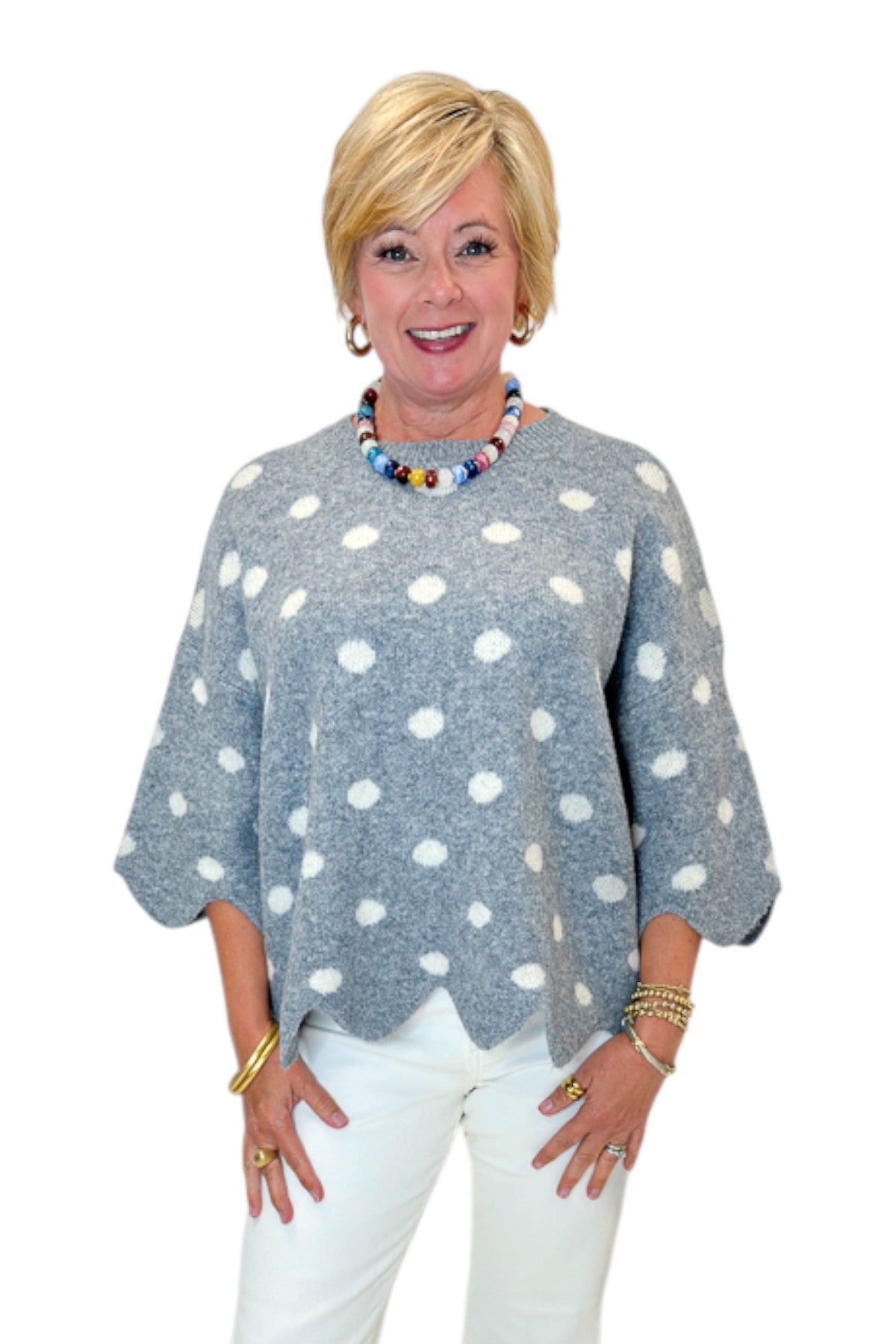 Front view of woman wearing Swagger Boutique’s Grey Polka Dot Short Sleeve Sweater by Entro with jeans against white studio background.