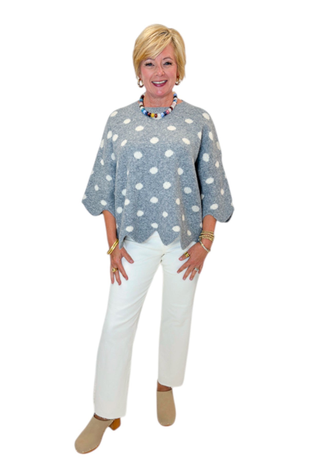 Front view of woman wearing Swagger Boutique’s Grey Polka Dot Short Sleeve Sweater by Entro with jeans against white studio background.