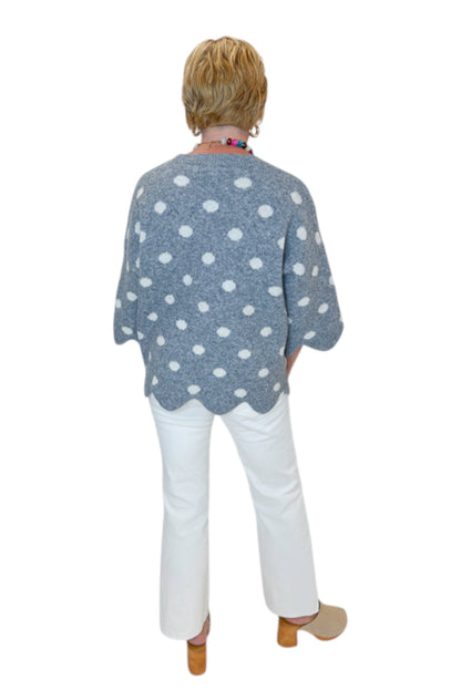 Back view of woman wearing Swagger Boutique’s Grey Polka Dot Short Sleeve Sweater by Entro with jeans against white studio background.