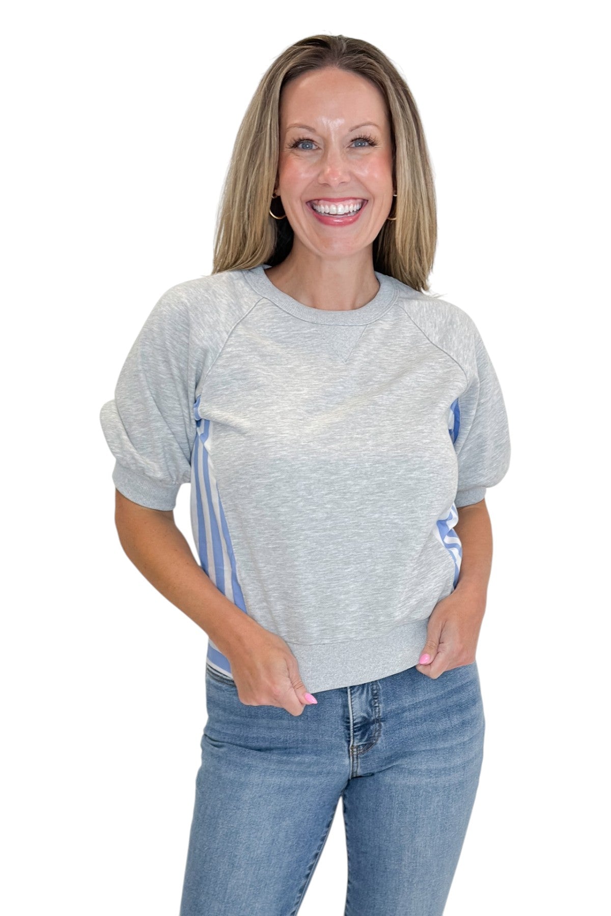 Front view of woman wearing Swagger Boutique’s Grey Striped Short Sleeve Sweatshirt with jeans against white studio background.