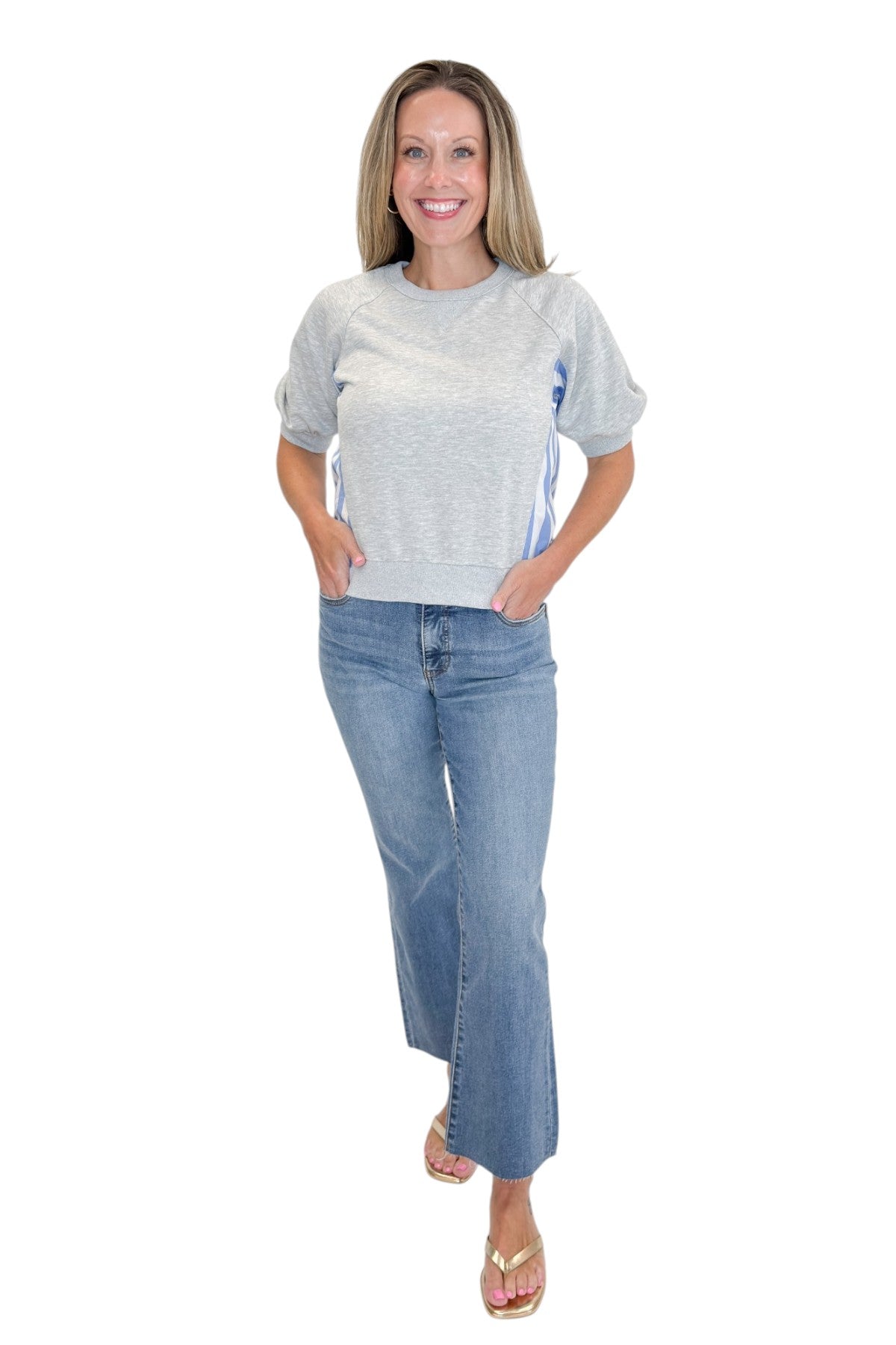 Front view of woman wearing Swagger Boutique’s Grey Striped Short Sleeve Sweatshirt with jeans against white studio background.