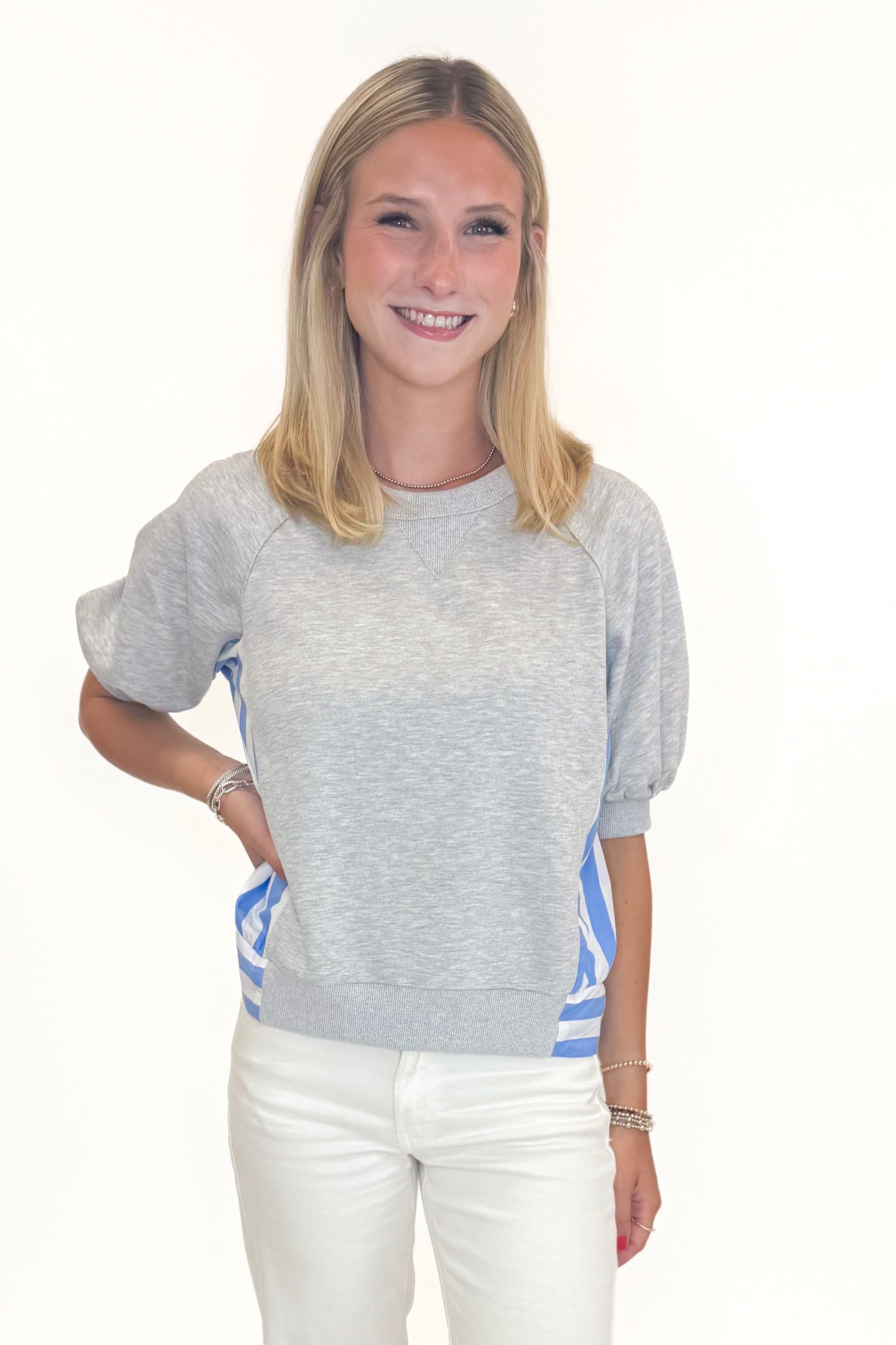Front view of woman wearing Swagger Boutique’s Grey Striped Short Sleeve Sweatshirt with jeans against white studio background.