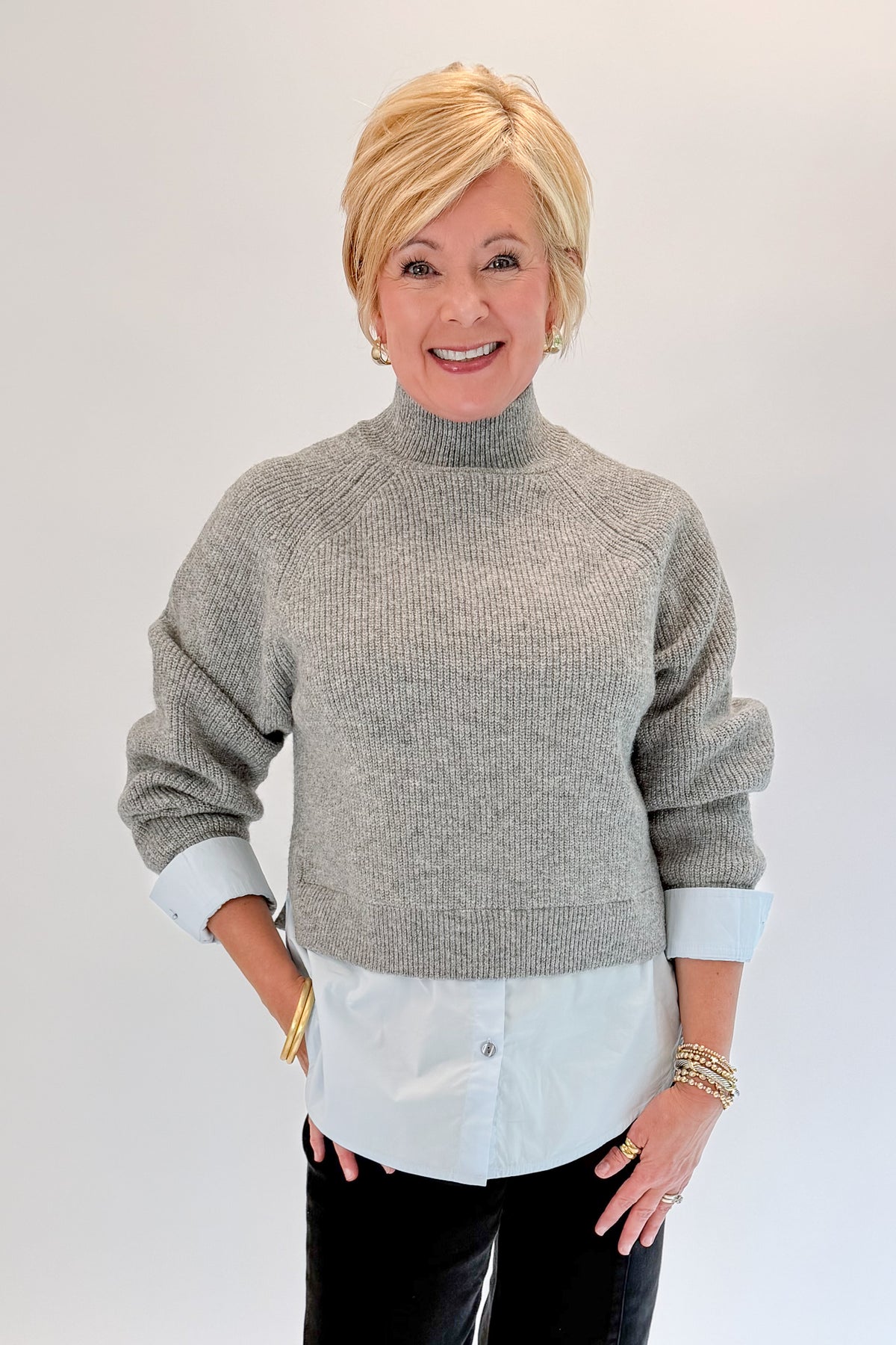 Front view of woman wearing Swagger Boutique’s Grey &amp; Blue Layered Sweater &amp; Shirt by Entro with jeans against white studio background.