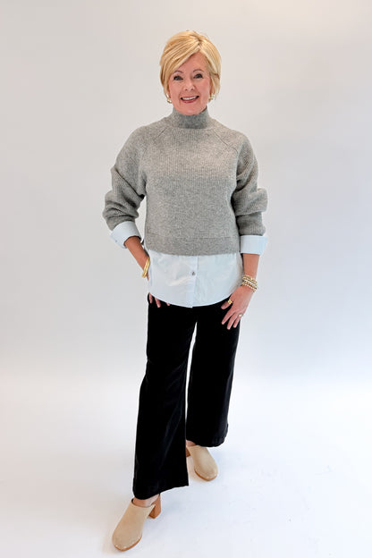 Front view of woman wearing Swagger Boutique’s Grey &amp; Blue Layered Sweater &amp; Shirt by Entro with jeans against white studio background.