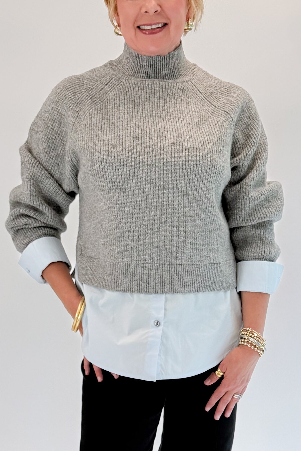 Front detail view of woman wearing Swagger Boutique’s Grey &amp; Blue Layered Sweater &amp; Shirt by Entro with jeans against white studio background.