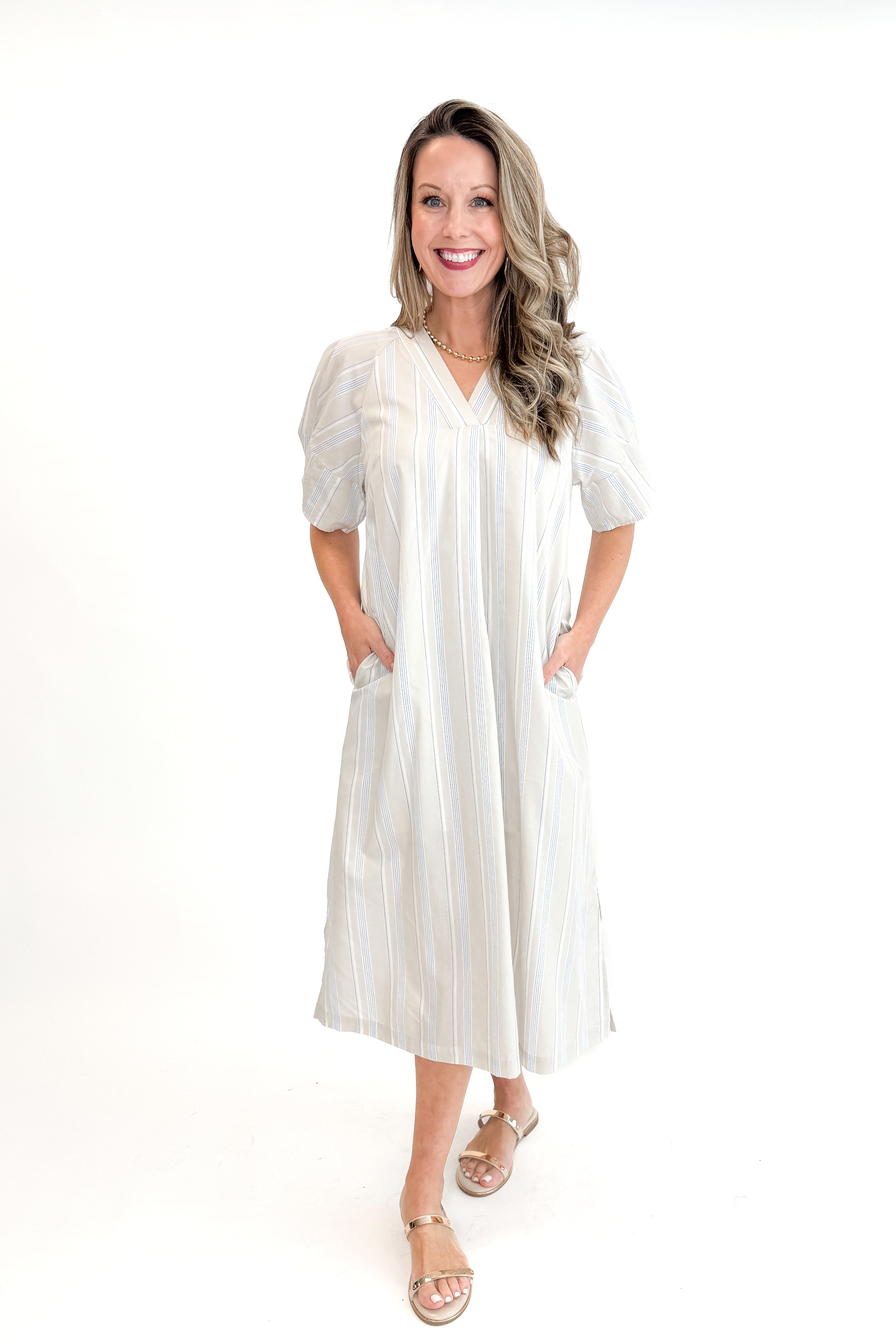 Front view of woman wearing Beige &amp; Light Blue Striped Midi Dress against white studio background.