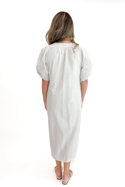 Back view of woman wearing Beige &amp; Light Blue Striped Midi Dress against white studio background.