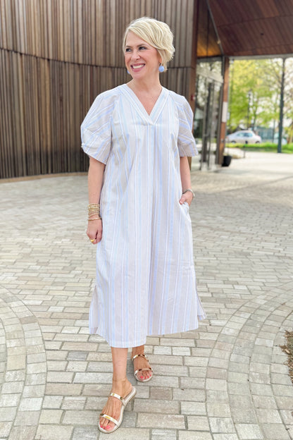 Front view of woman wearing Beige &amp; Light Blue Striped Midi Dress with sandals outside at a park.