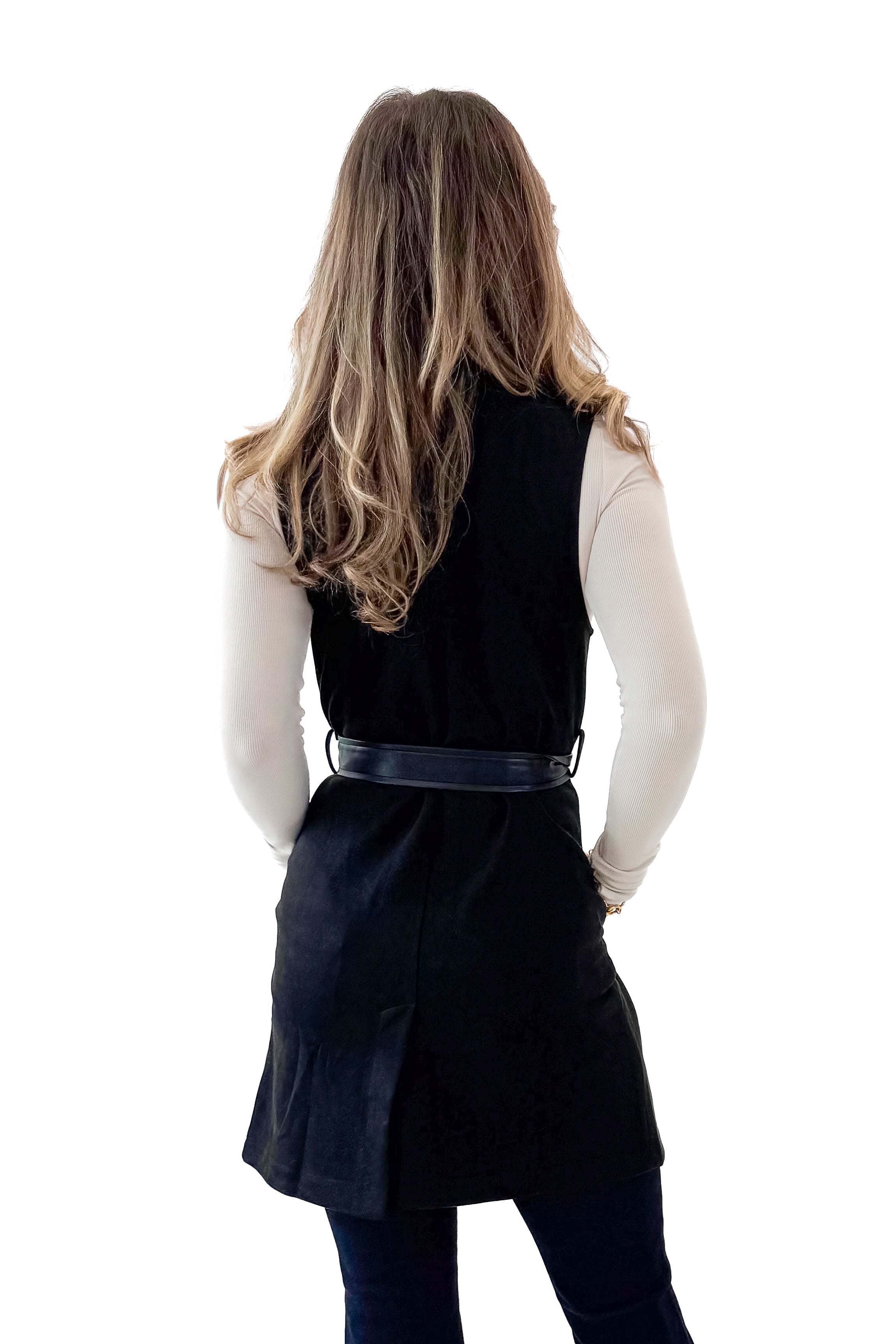 Back view of woman wearing Black Suede Long Vest with jeans against white studio background.