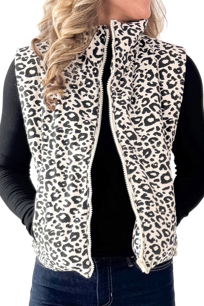 Front detailed view of woman wearing Cream Leopard Puffer Vest with jeans against white studio background.