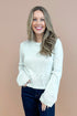 Woman wearing Grey Cutout Detail Sweater and blue jeans. 