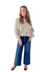 Front view of woman wearing Light Mocha Button Up Cardigan with jeans against white studio background.