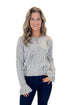 Front view of woman wearing Grey Button Up Bow Detail Sweater with jeans against white studio background.