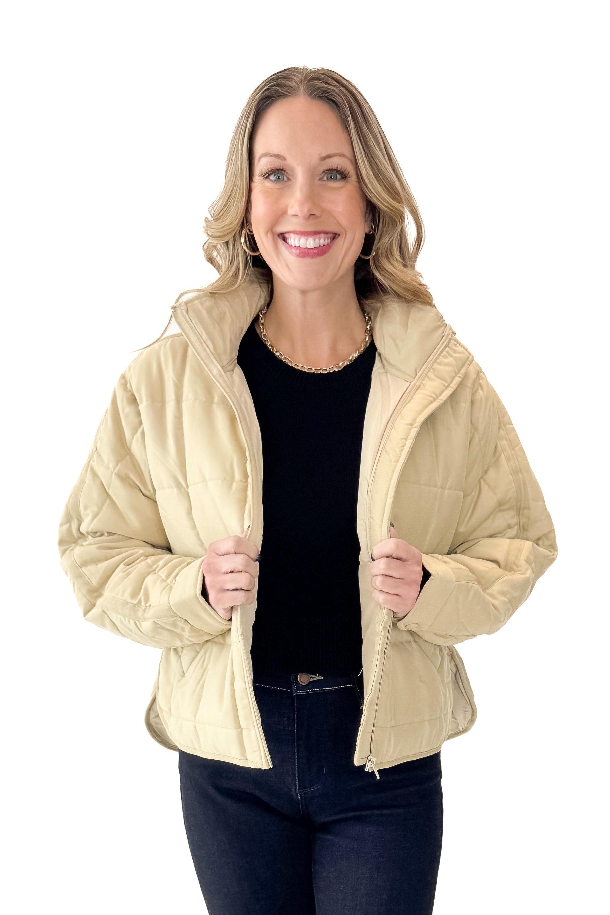 Front view of woman wearing Beige Quilted Puffer Jacket with jeans against white studio background.