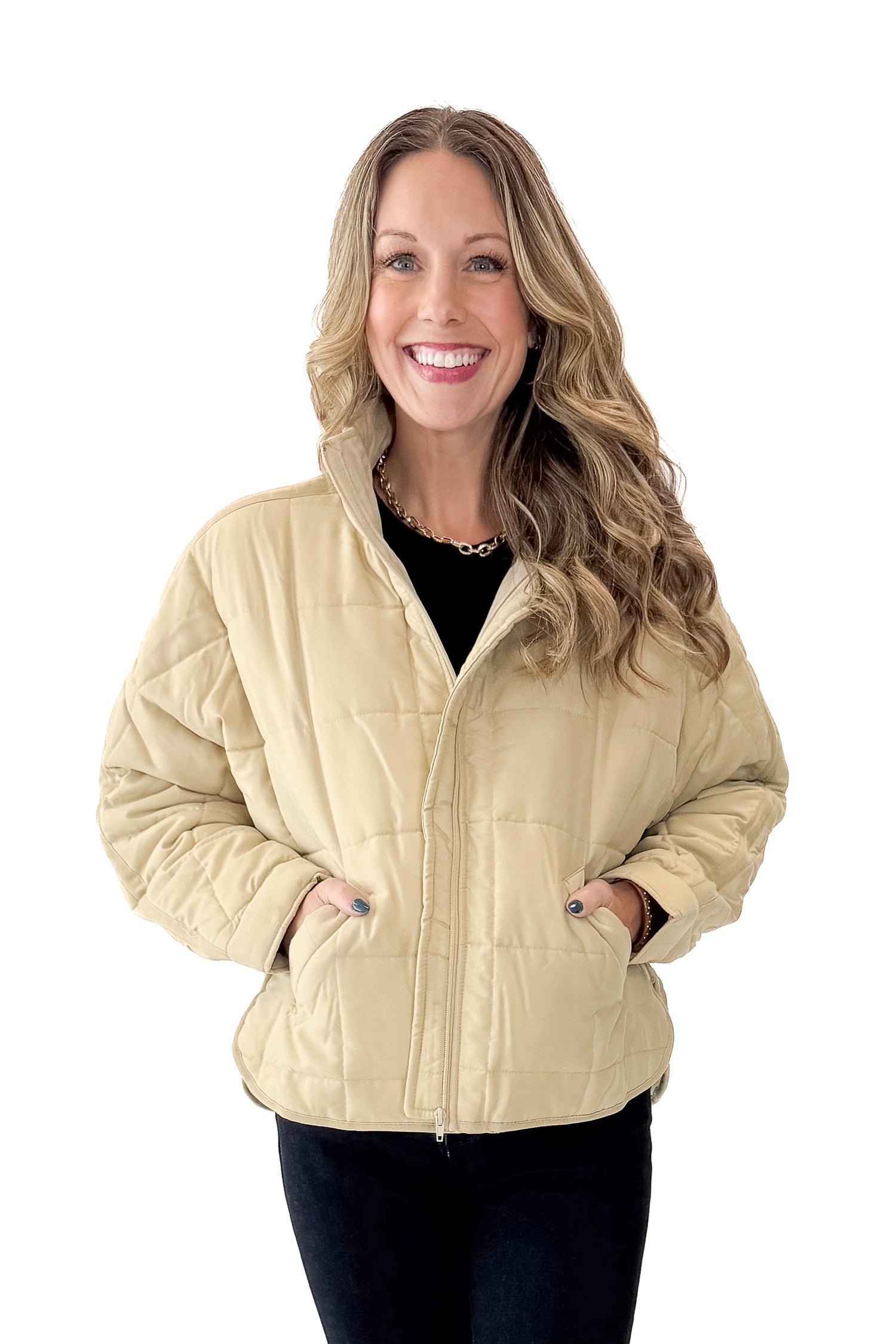 Front view of woman wearing Beige Quilted Puffer Jacket with jeans against white studio background.