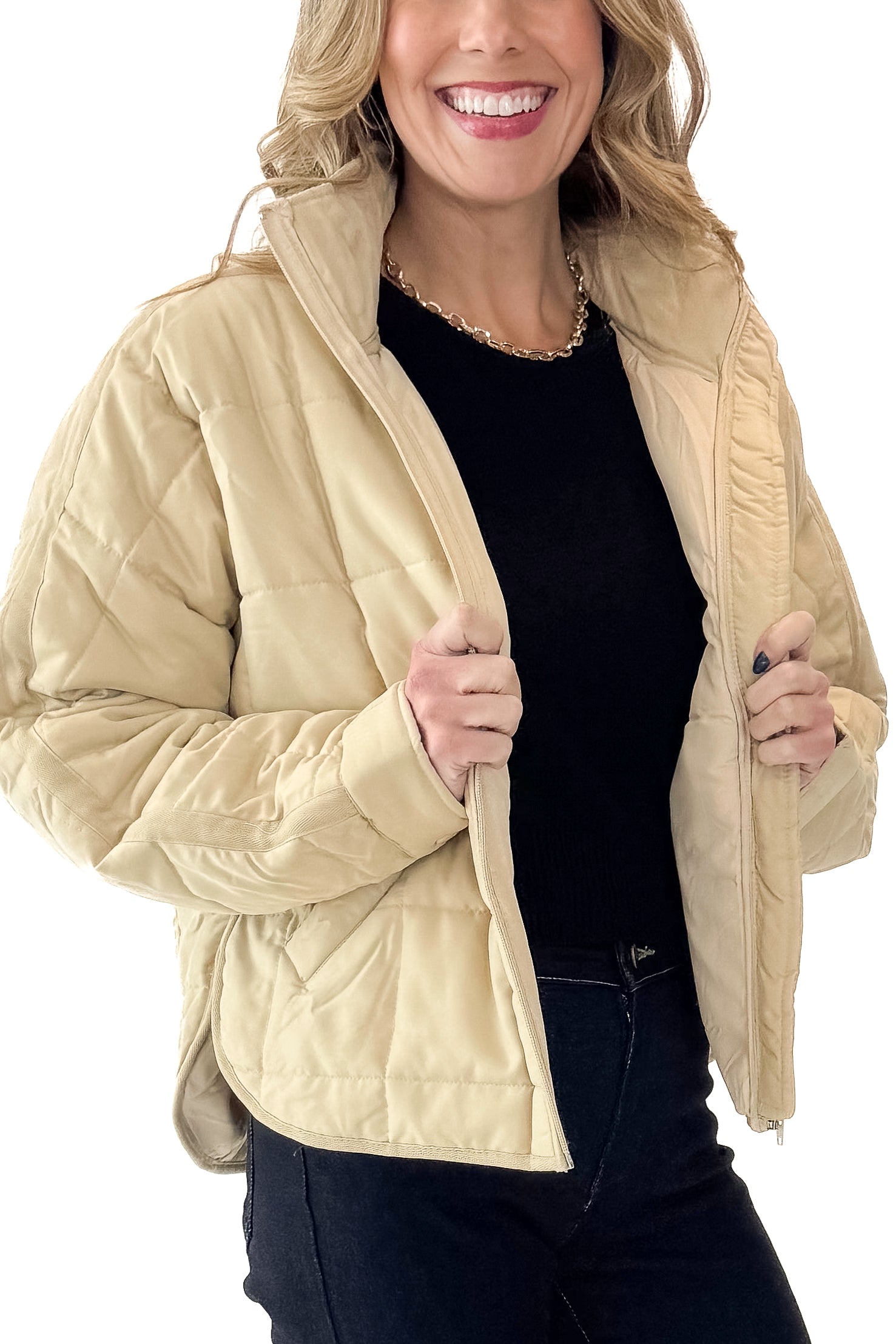 Side detail view of woman wearing Beige Quilted Puffer Jacket with jeans against white studio background.