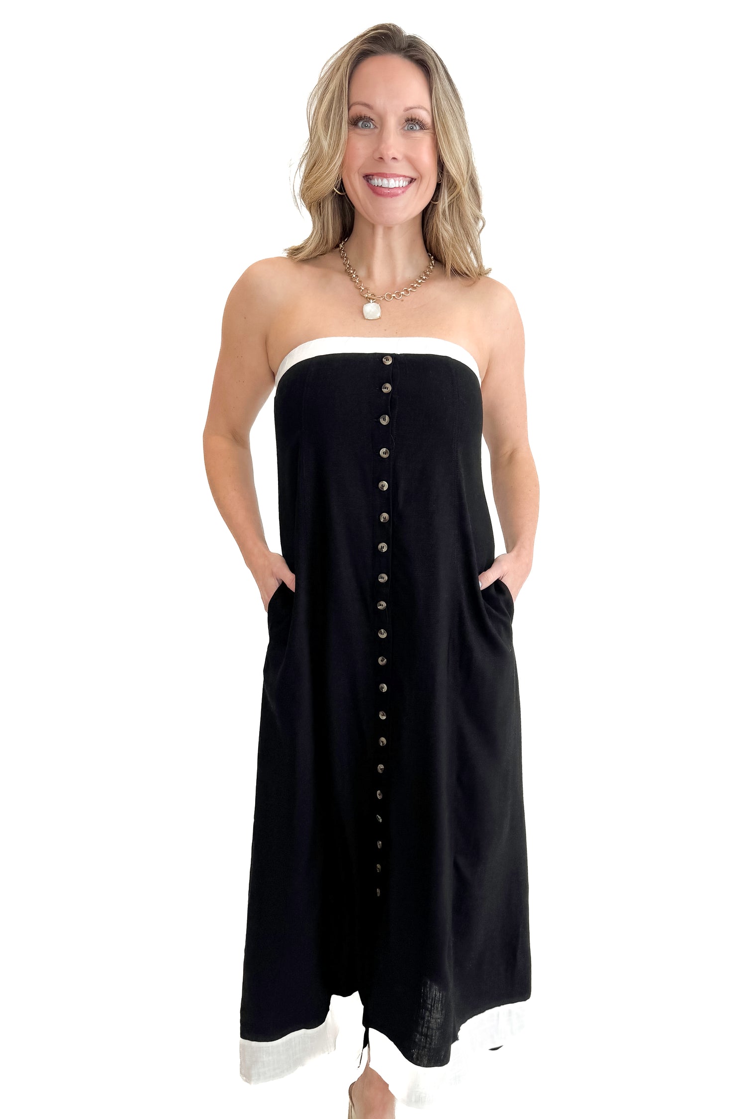 Front view of woman wearing Black With White Lining Button Down Strapless Dress against white studio background.