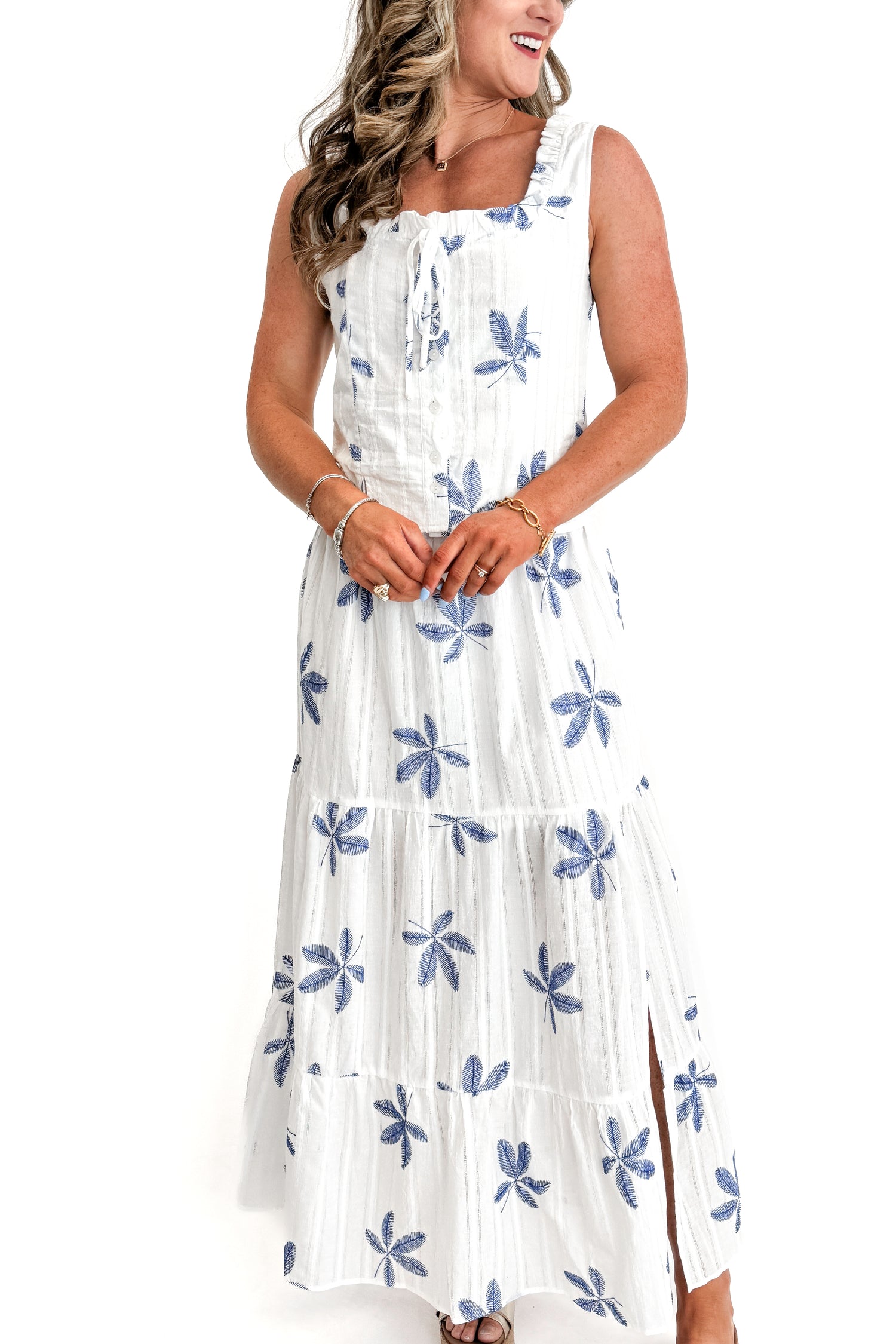 Front view of woman wearing White With Blue Embroidery Top with matching skirt against white studio background.